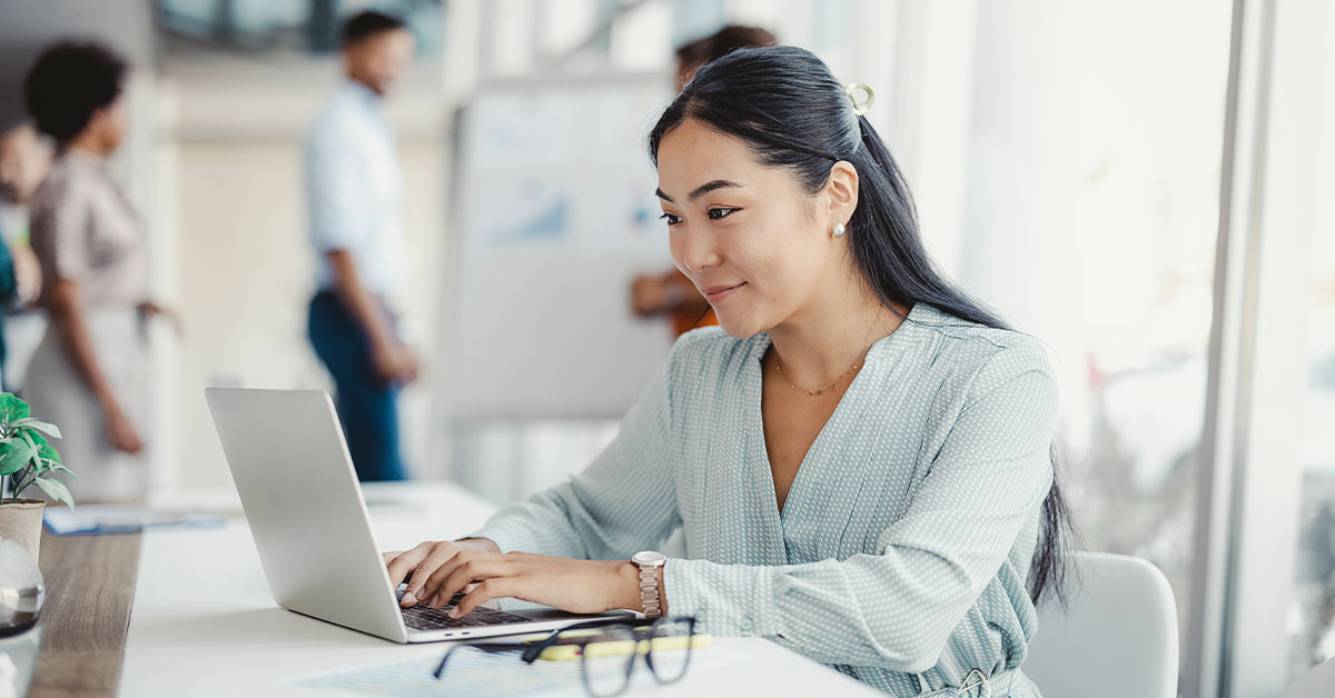 a person sitting at a table using a laptop